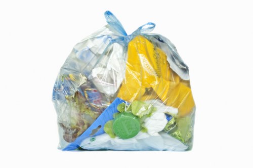 Operative wearing PPE performing a vehicle inspection during waste collection