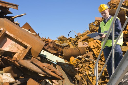 Insured skip hire team discussing safety procedures before work
